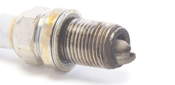 Worn or broken electrode on lawn mower spark plug